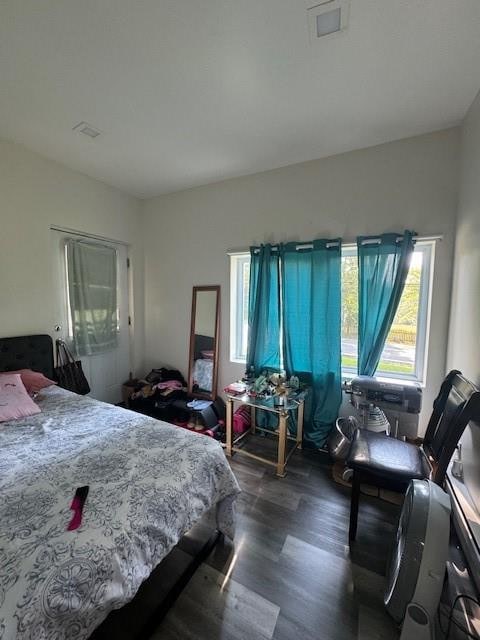 bedroom with dark hardwood / wood-style flooring