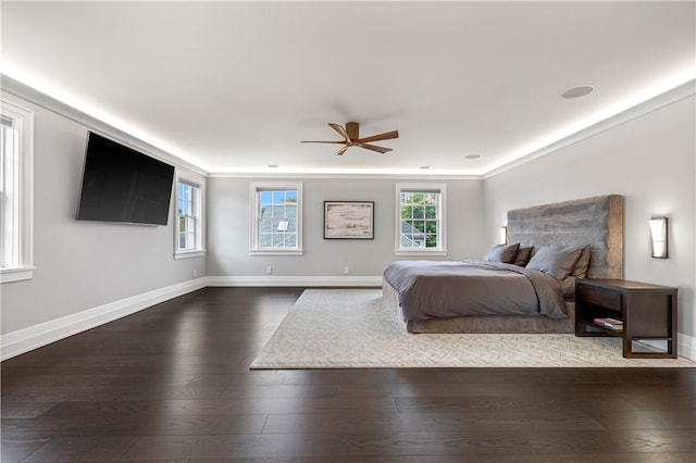 bedroom featuring ceiling fan, dark hardwood / wood-style floors, and ornamental molding