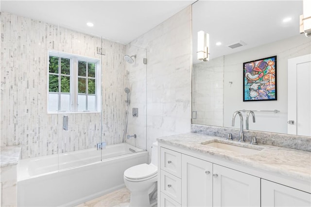 full bathroom with shower / bath combination with glass door, vanity, and toilet