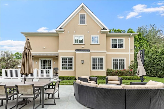 rear view of house with an outdoor living space and a patio