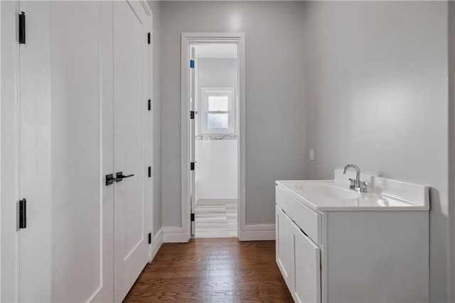 bathroom with hardwood / wood-style floors and vanity