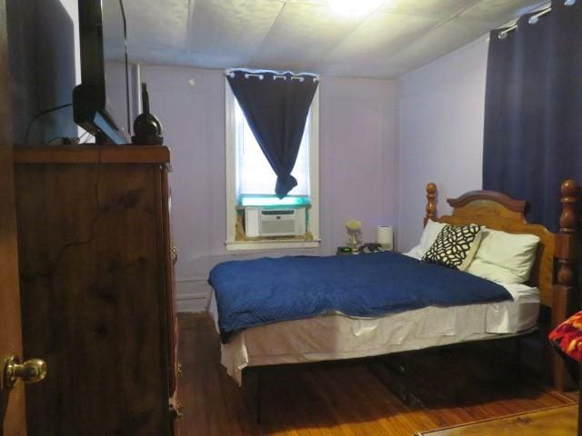 bedroom featuring cooling unit and wood-type flooring