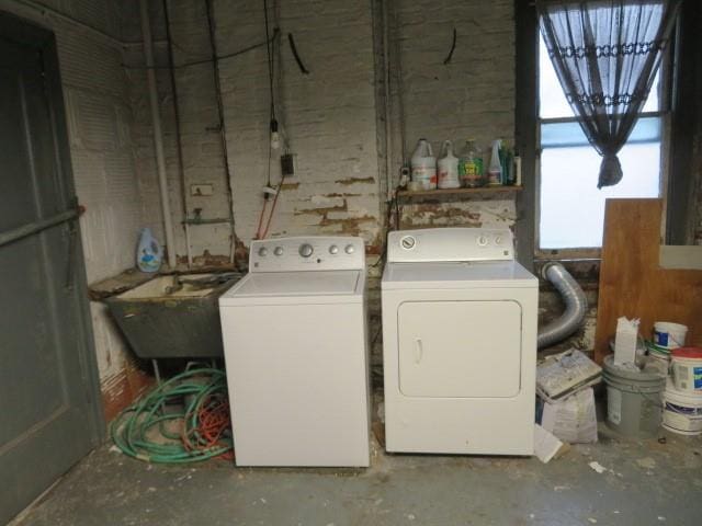 clothes washing area featuring washer and dryer and sink