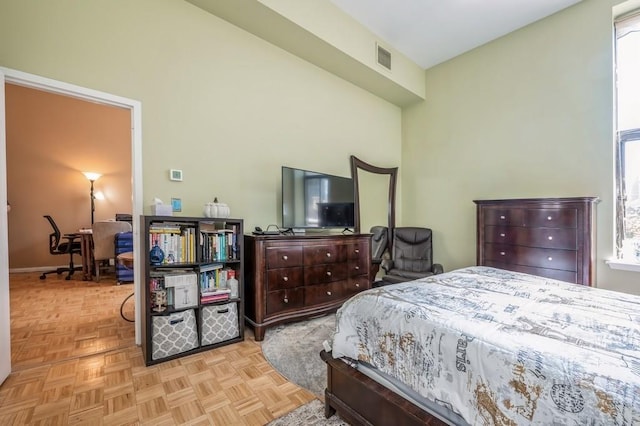 bedroom with light parquet flooring