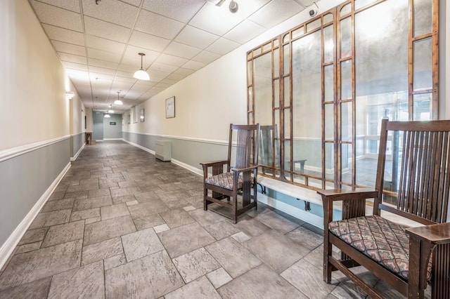 hallway featuring a paneled ceiling