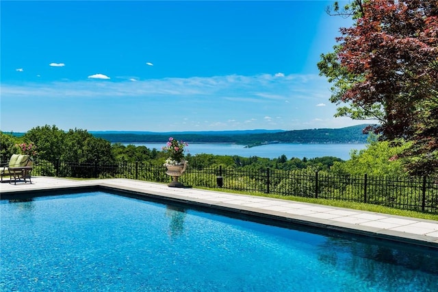 view of swimming pool featuring a water view