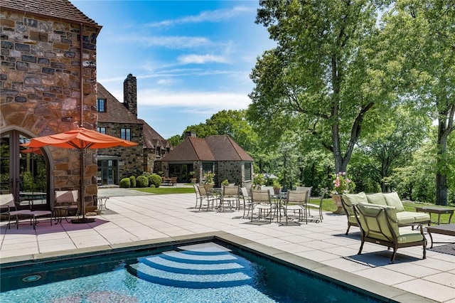 view of swimming pool featuring a patio