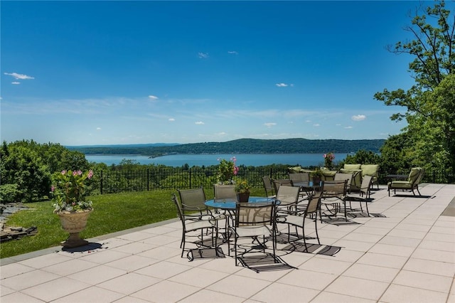 view of patio / terrace featuring a water and mountain view