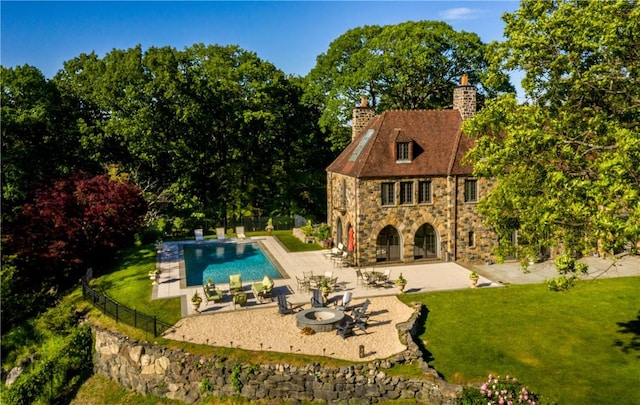 view of pool with a lawn and a patio area