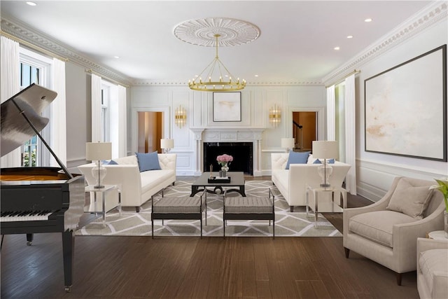 living room with wood-type flooring, a wealth of natural light, and ornamental molding