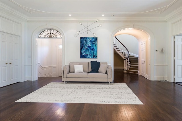 living room with dark hardwood / wood-style floors and ornamental molding