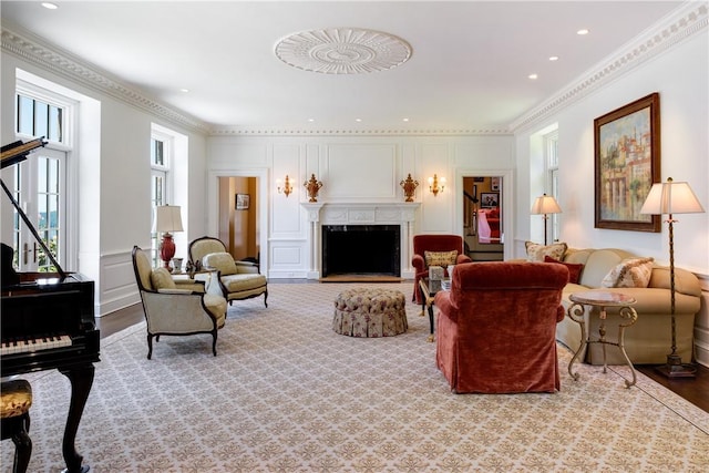 11 Carriage Trl, Tarrytown, NY 10591 - living room with a fireplace with flush hearth, wood finished floors, a decorative wall, recessed lighting, and ornamental molding