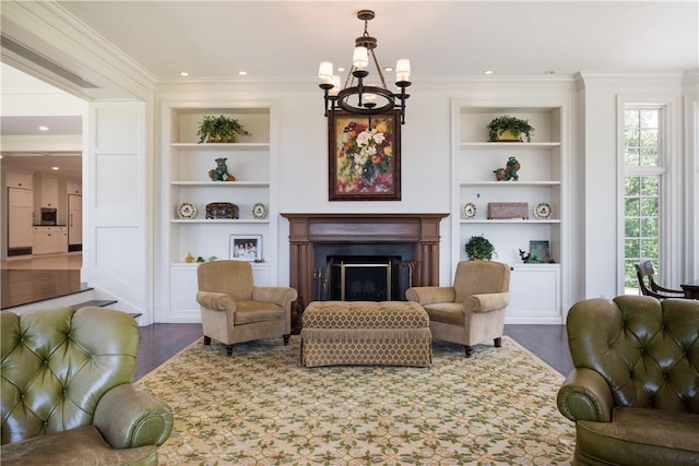 living room with ornamental molding, built in features, dark wood-type flooring, and a notable chandelier