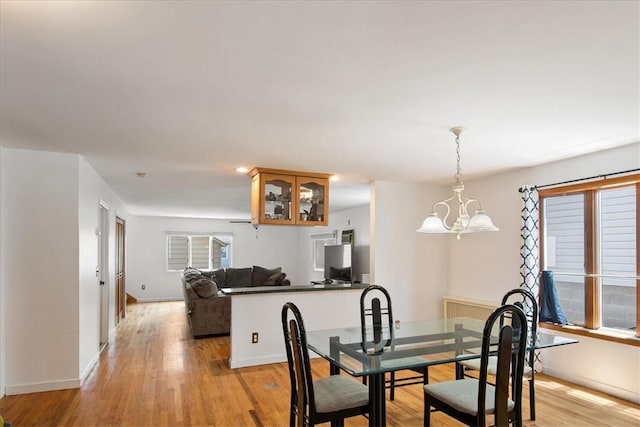 dining room featuring an inviting chandelier and light wood-type flooring