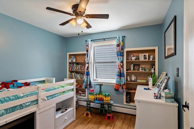 bedroom with ceiling fan, light hardwood / wood-style floors, and a baseboard radiator