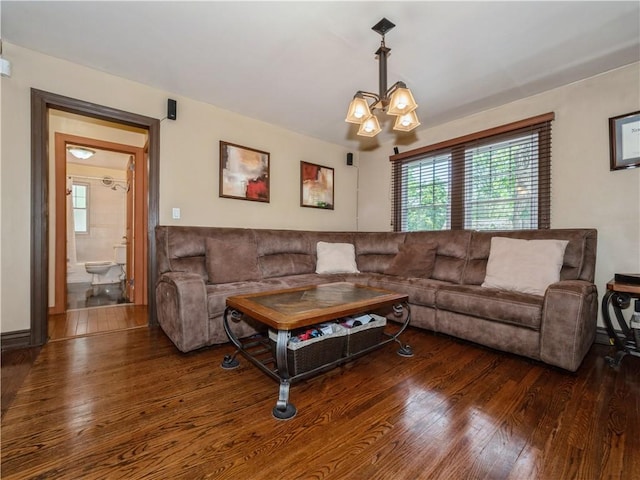 living room featuring dark hardwood / wood-style floors and a notable chandelier