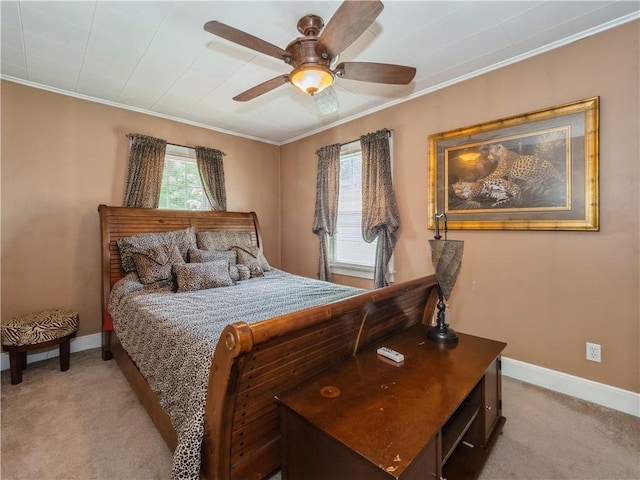 carpeted bedroom with ceiling fan and crown molding