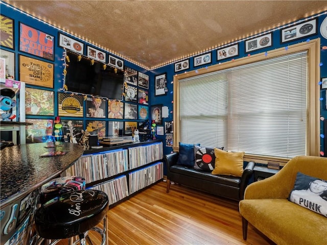 sitting room with a textured ceiling and hardwood / wood-style flooring