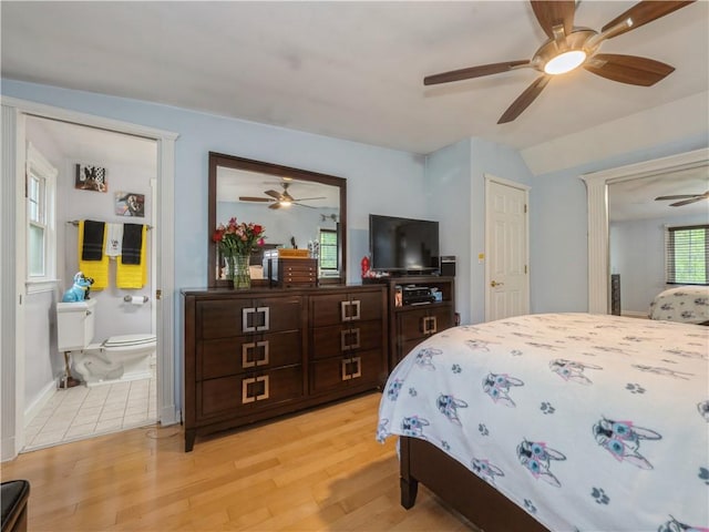 bedroom with connected bathroom, ceiling fan, and light hardwood / wood-style floors