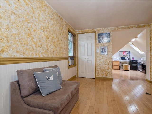 sitting room featuring hardwood / wood-style floors and vaulted ceiling