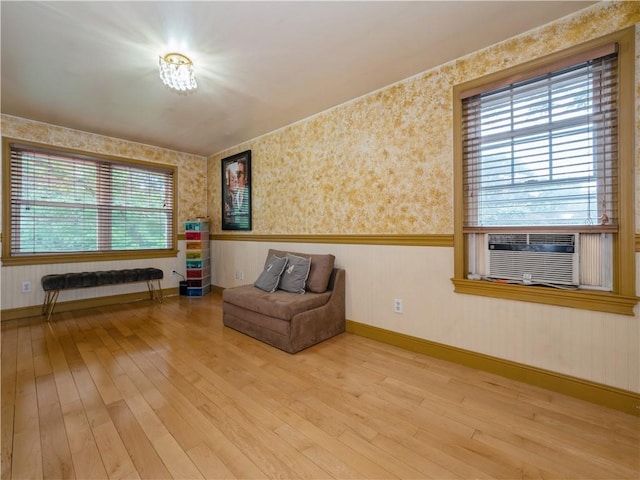 unfurnished room with a wealth of natural light, hardwood / wood-style floors, and cooling unit