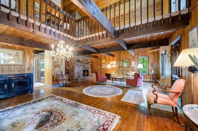 living room featuring hardwood / wood-style flooring, wood walls, wood ceiling, and beam ceiling