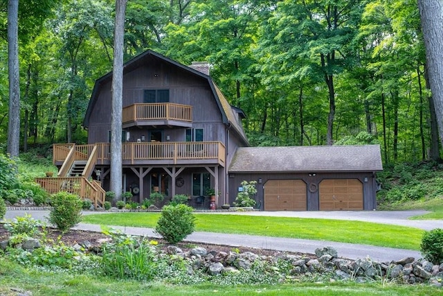 view of front of house with a garage and a front lawn