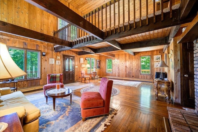 living room featuring wood walls, a healthy amount of sunlight, and hardwood / wood-style flooring