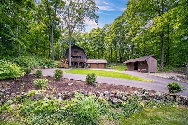 surrounding community featuring a garage and a storage shed