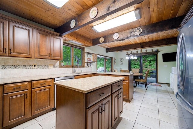 kitchen with beam ceiling, a kitchen island, wooden ceiling, and light tile patterned flooring