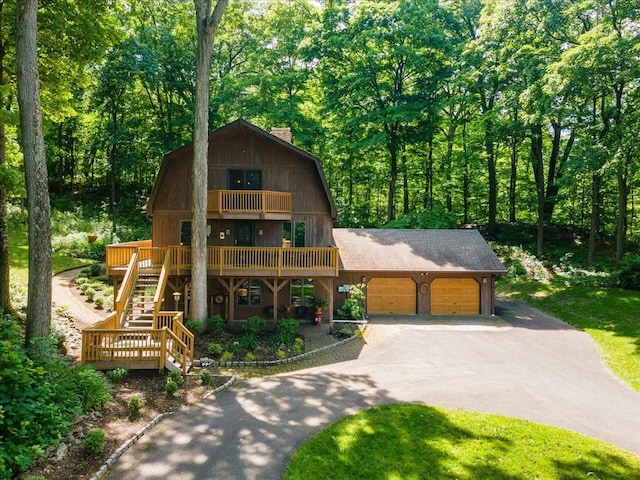 view of front of property with a balcony and a garage