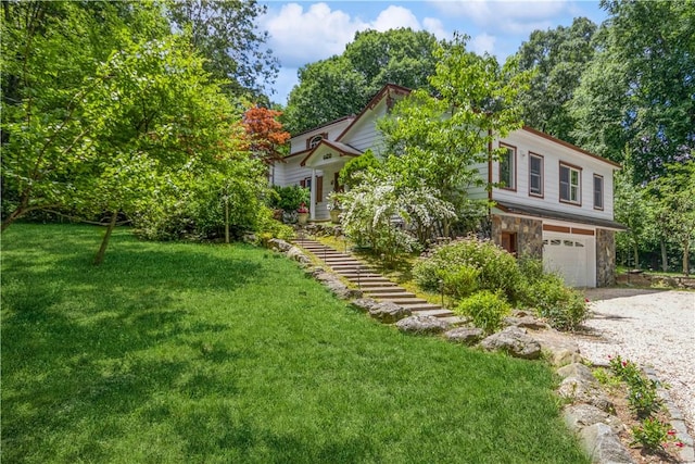 view of front of house featuring a garage and a front yard