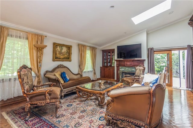 living room featuring french doors, light parquet floors, crown molding, and vaulted ceiling with skylight