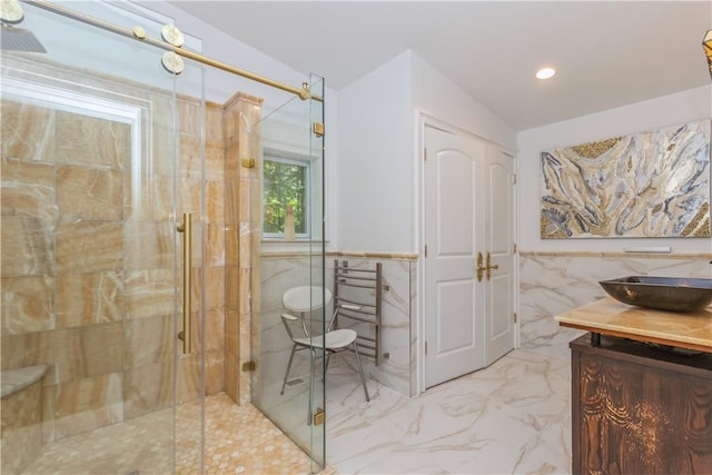 bathroom featuring vanity, tile walls, and walk in shower