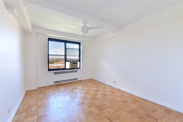 empty room featuring ceiling fan, cooling unit, radiator heating unit, and light parquet floors