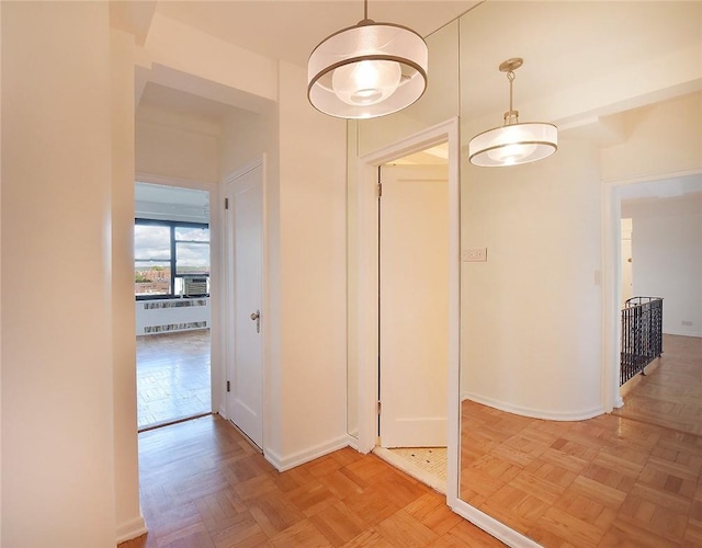 hallway featuring cooling unit, radiator, and light parquet floors