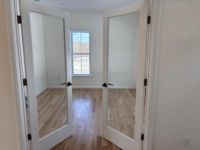 interior space featuring light wood-type flooring and french doors