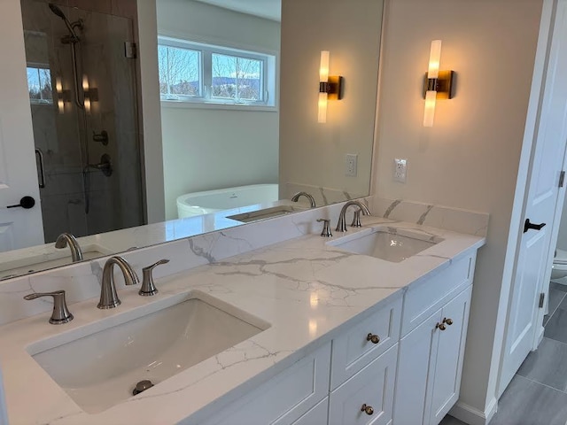 bathroom featuring a shower with door and vanity