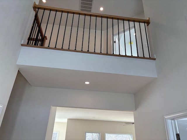 staircase featuring a high ceiling