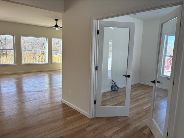 interior space with light hardwood / wood-style floors, french doors, and ceiling fan