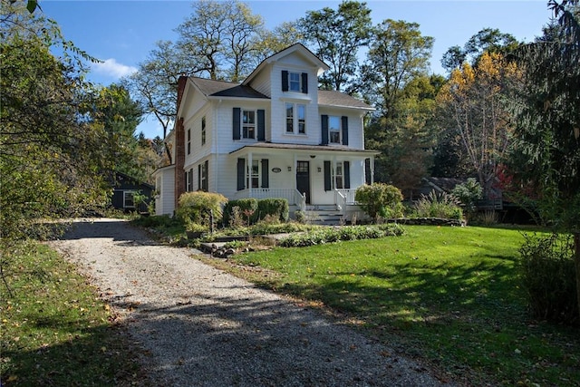 view of front of home featuring a porch and a front lawn