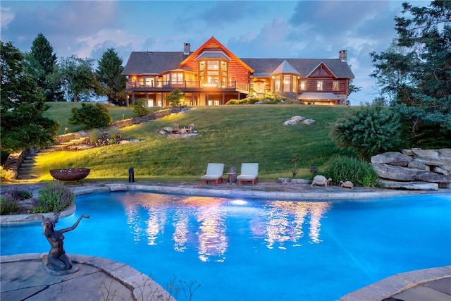 pool at dusk with a lawn