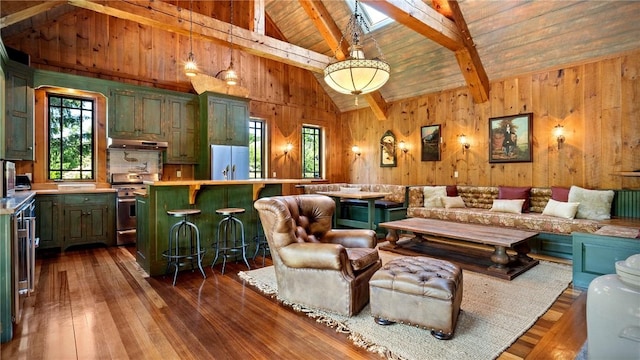 living room with beamed ceiling, wood walls, dark hardwood / wood-style flooring, and wooden ceiling