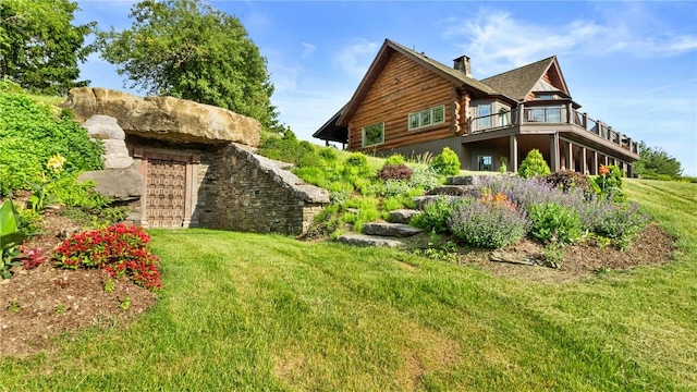 view of property exterior with a balcony and a yard