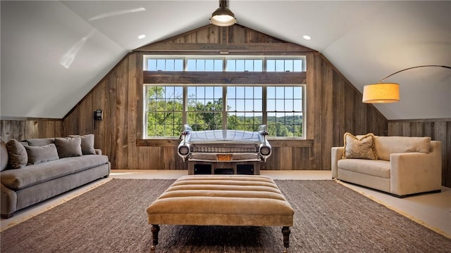 living area featuring wood walls and lofted ceiling