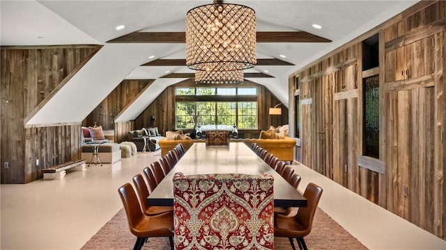 dining room featuring lofted ceiling and wooden walls