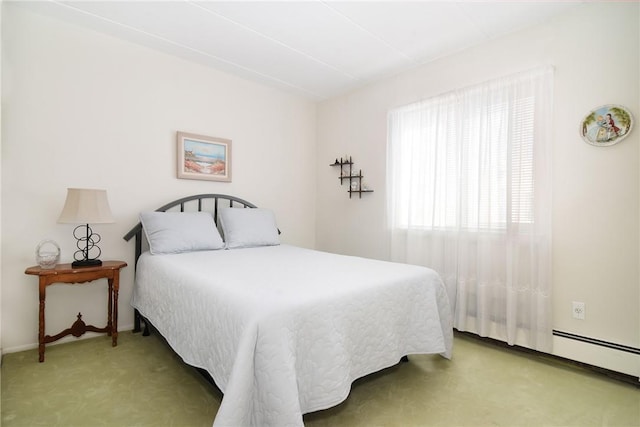 bedroom with light colored carpet and baseboard heating