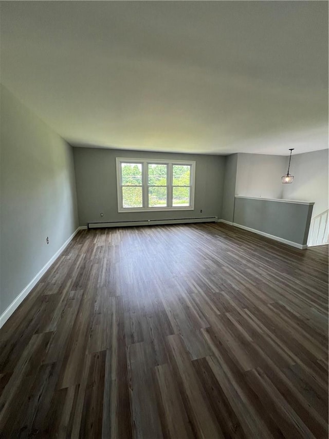 unfurnished room with dark hardwood / wood-style floors and a baseboard radiator