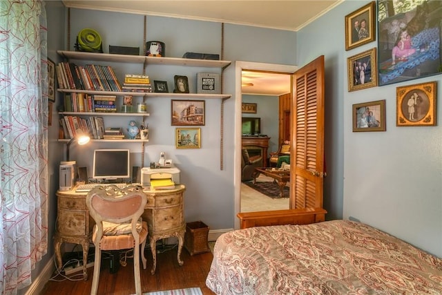 bedroom with hardwood / wood-style floors and ornamental molding