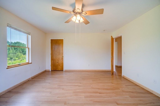 unfurnished room with ceiling fan and light wood-type flooring